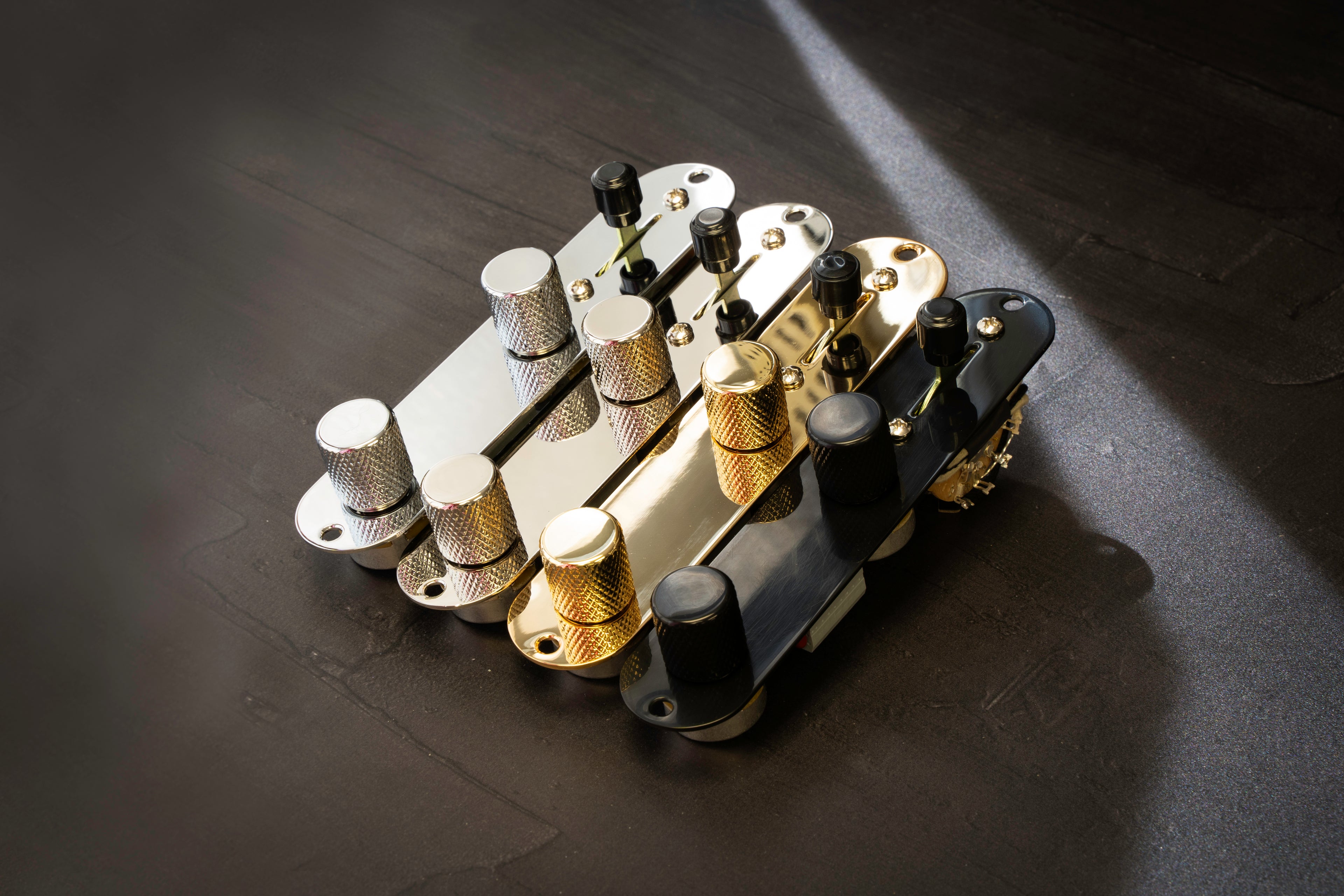 a row of obsidianwire loaded control plates for telecaster with chrome, nickel, black and gold options.